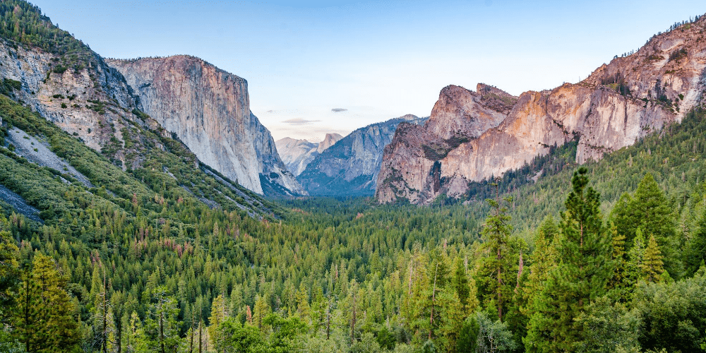 Yosemite tunnel view with mountains and forest during sunny day with clear blue sky