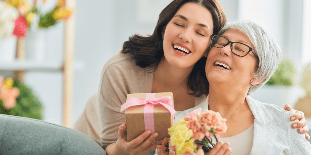 a woman giving a present to her mother