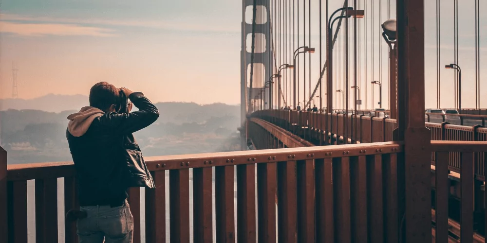 a person taking picture of the Golden Gate Bridge