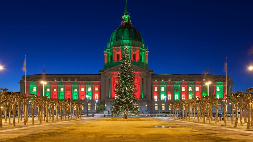 San Francisco City Hall illuminated with red and green Christmas lights