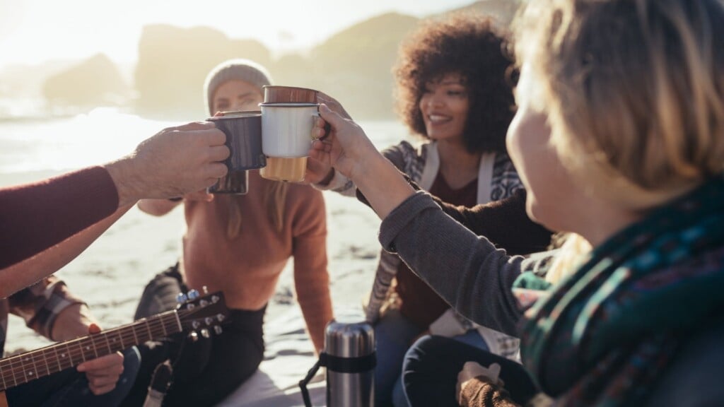 group of people toasting their mugs 