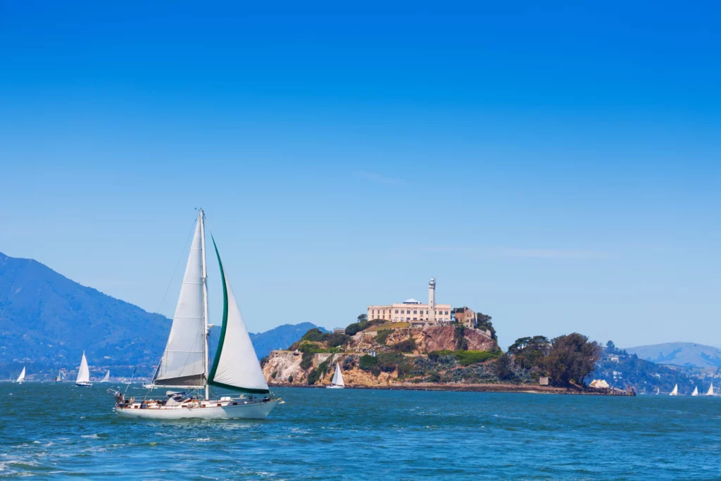 a yacht sailing in front of alcatraz island