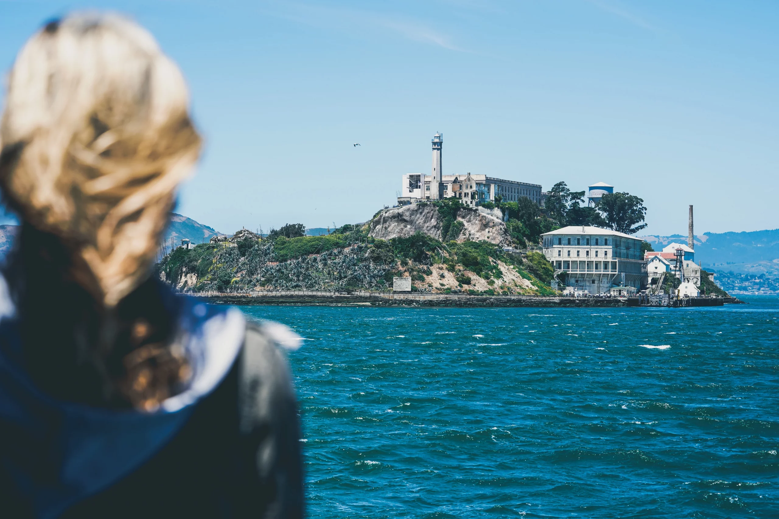 Alcatraz island view over the blonde girl's shoulder