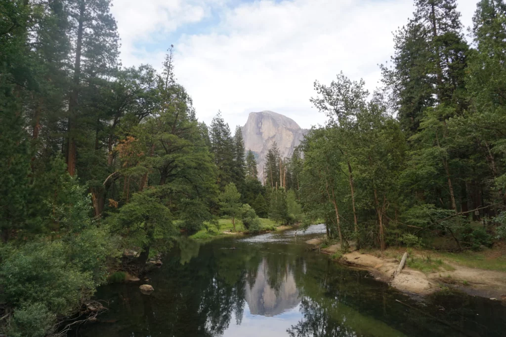 picture of half dome with its reflection in the river