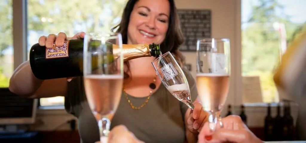 Woman pouring wine into the glass