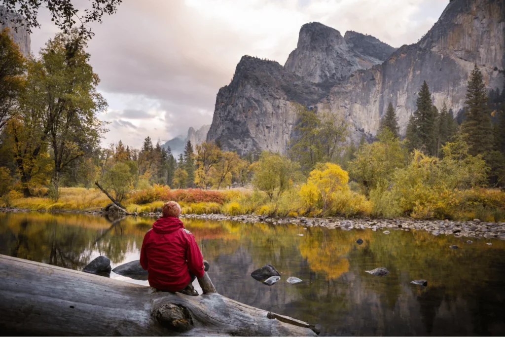 guy watching mirror lake during fall