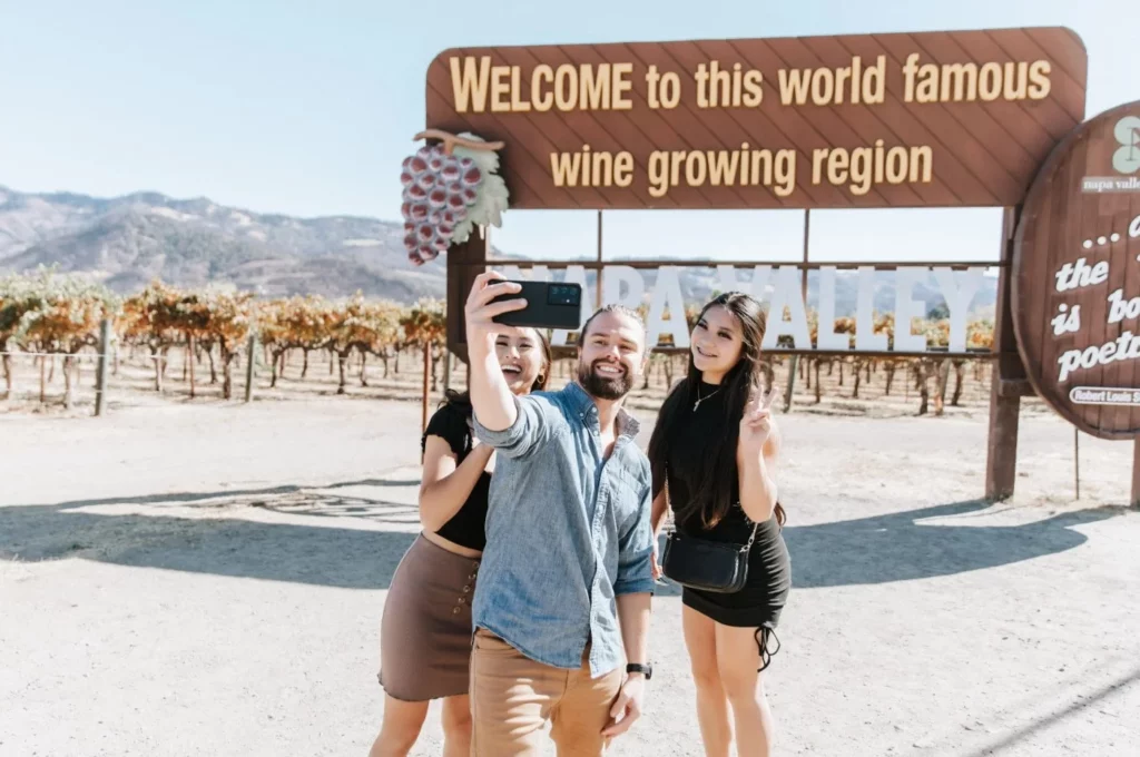 people taking selfie in front of napa valley sign 