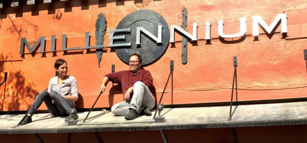 people sitting in front of millennium restaurant sign