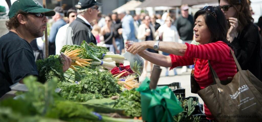 woman buying vegetables on ferry building marketplace