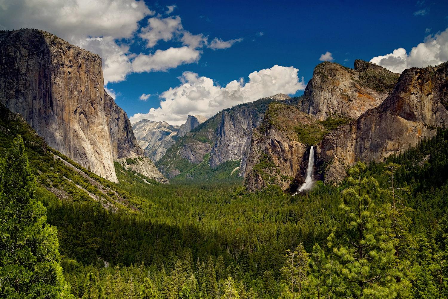 tunnel view with yosemite waterfall and blue sky in the background