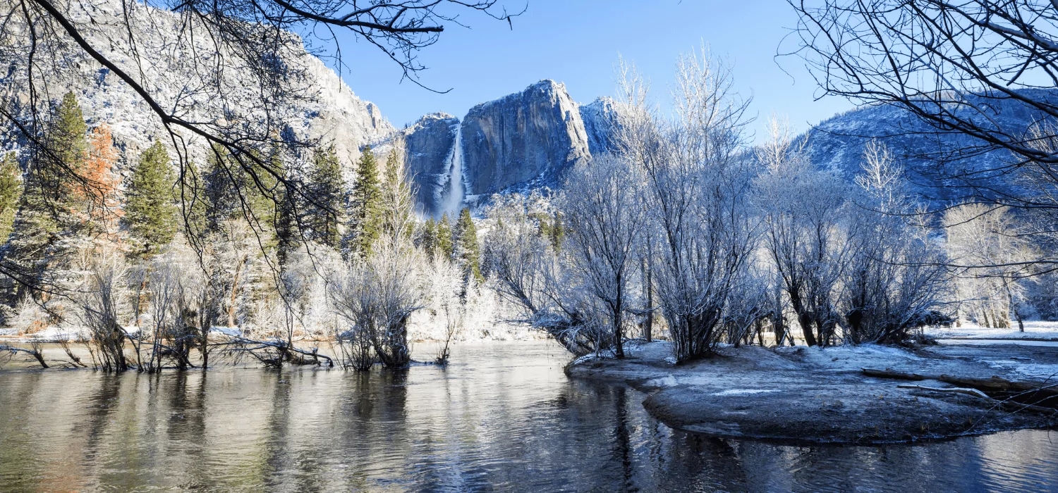 winter view of yosemite valley with snow-covered forest and mountains