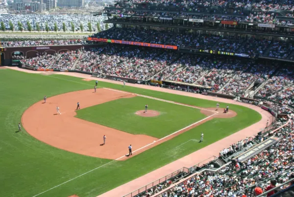 people watching a game in a baseball field 