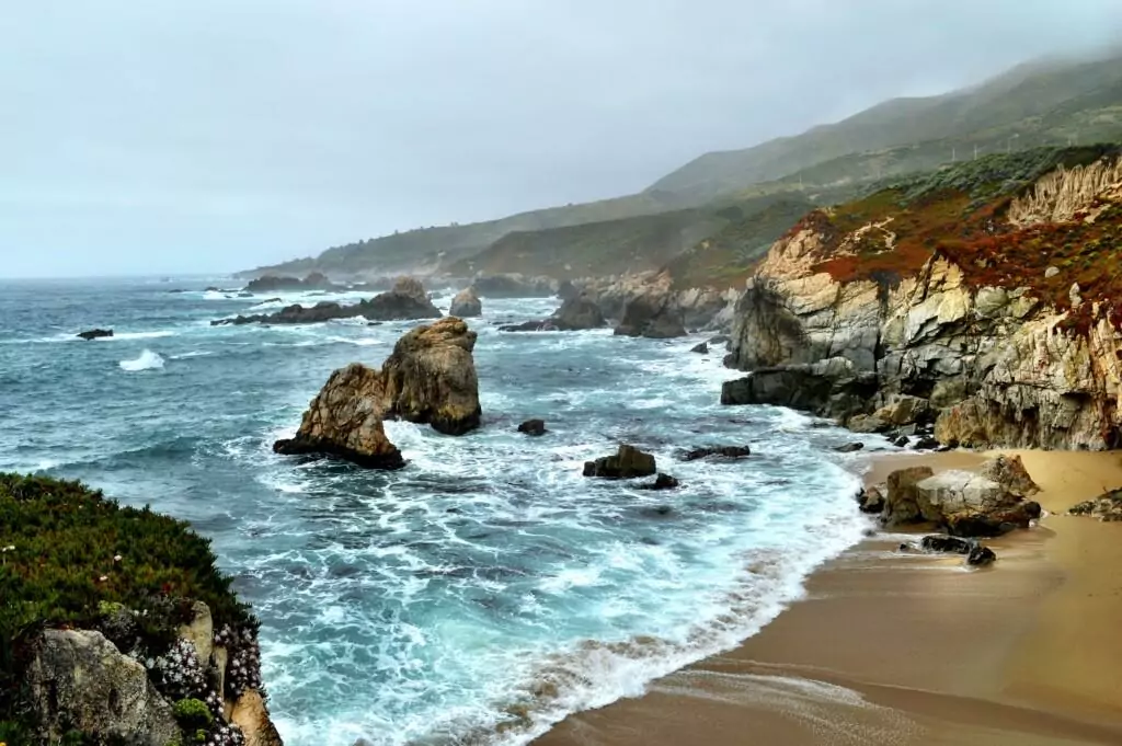 a view of carmel's beach with waves crashing on the shore