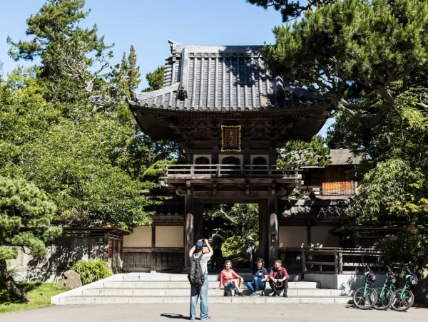 group of people taking photos in front on the Japanese tea garden entrance