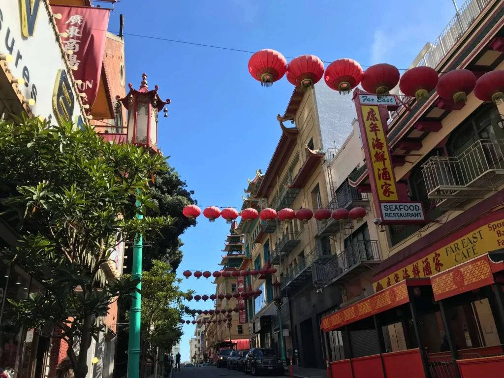 A Chinatown street lined with tall buildings and red lanterns