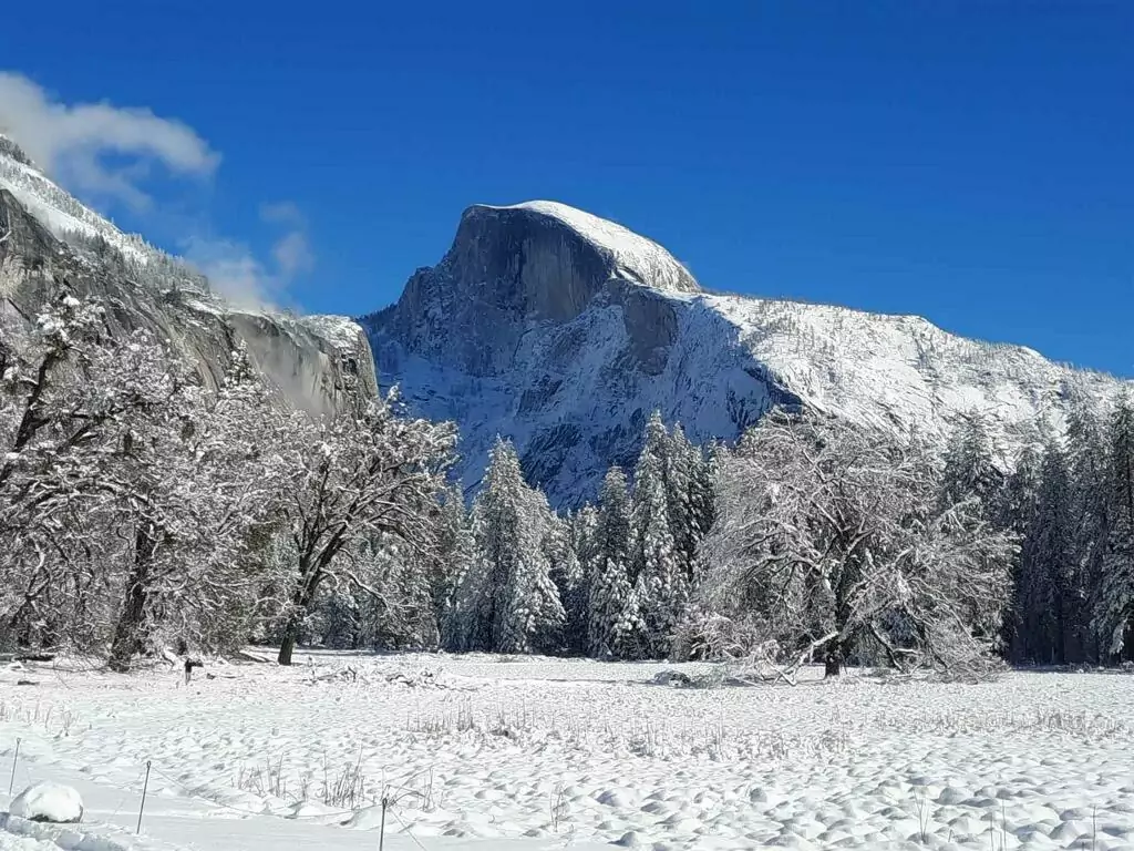 A mountainous snowscape featuring Half Dome in Yosemite.