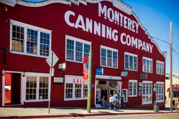 people walking outside the Monterey Canning Company building in Cannery Row.