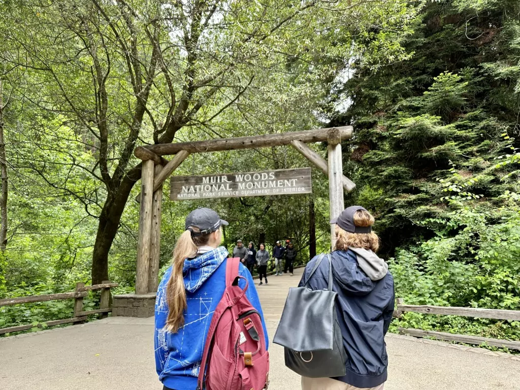 two people walking though Muir woods park entryway