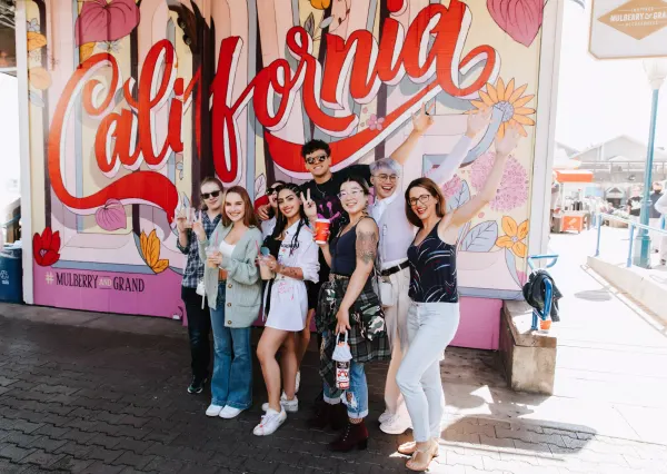 group of people taking photos in front of a signage 