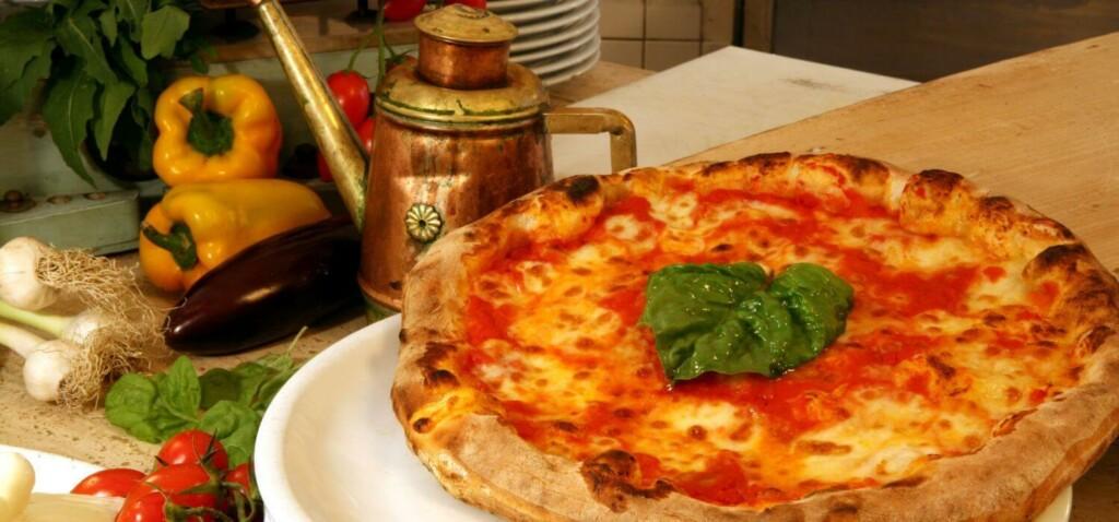 pizza napoletana on the table with vegetables