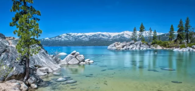clear lake tahoe and snowy mountain tops