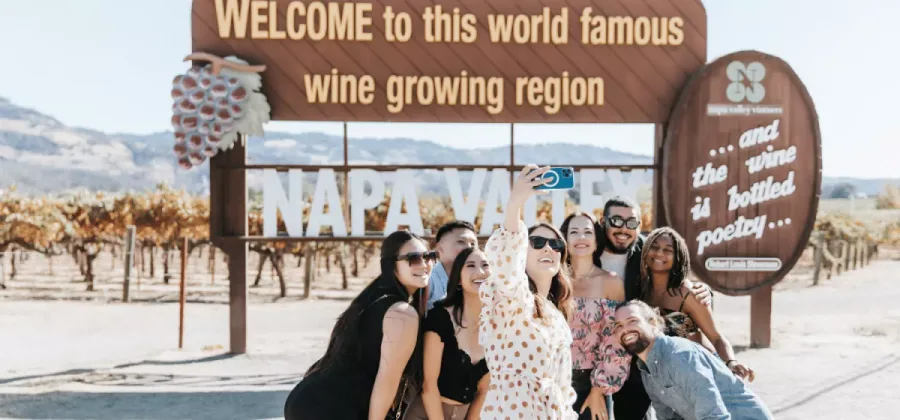 group of people taking photo in front of the napa sign