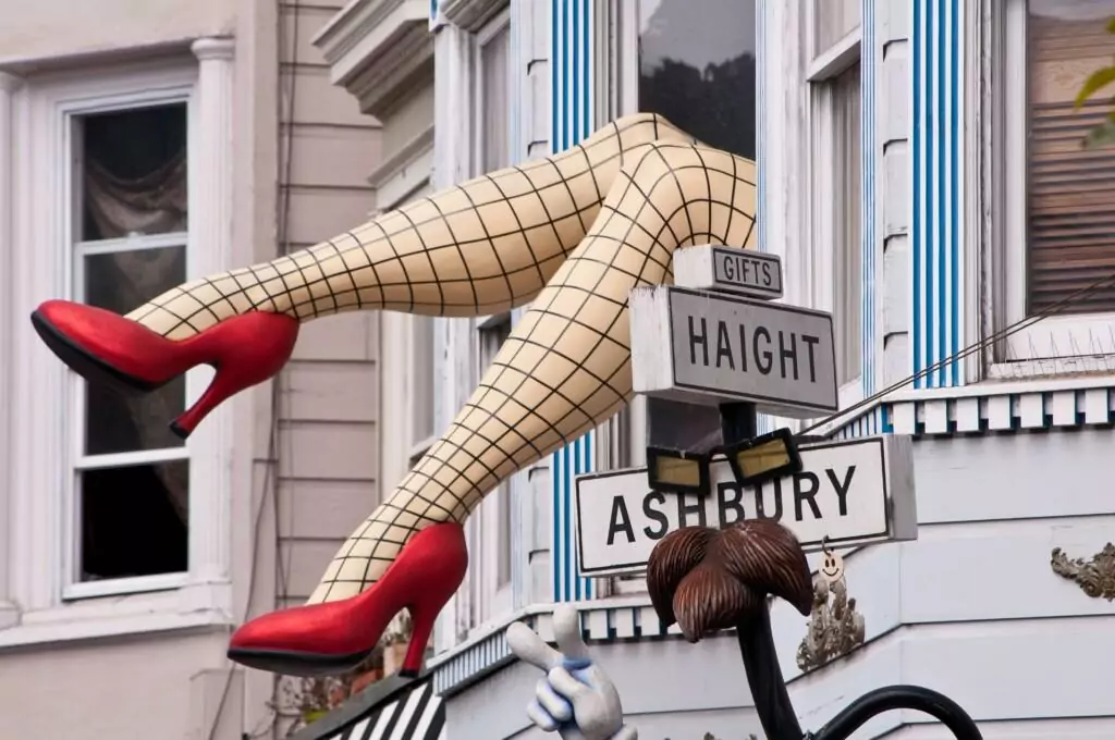 famous haight ashbury street sign with a woman's legs in the air