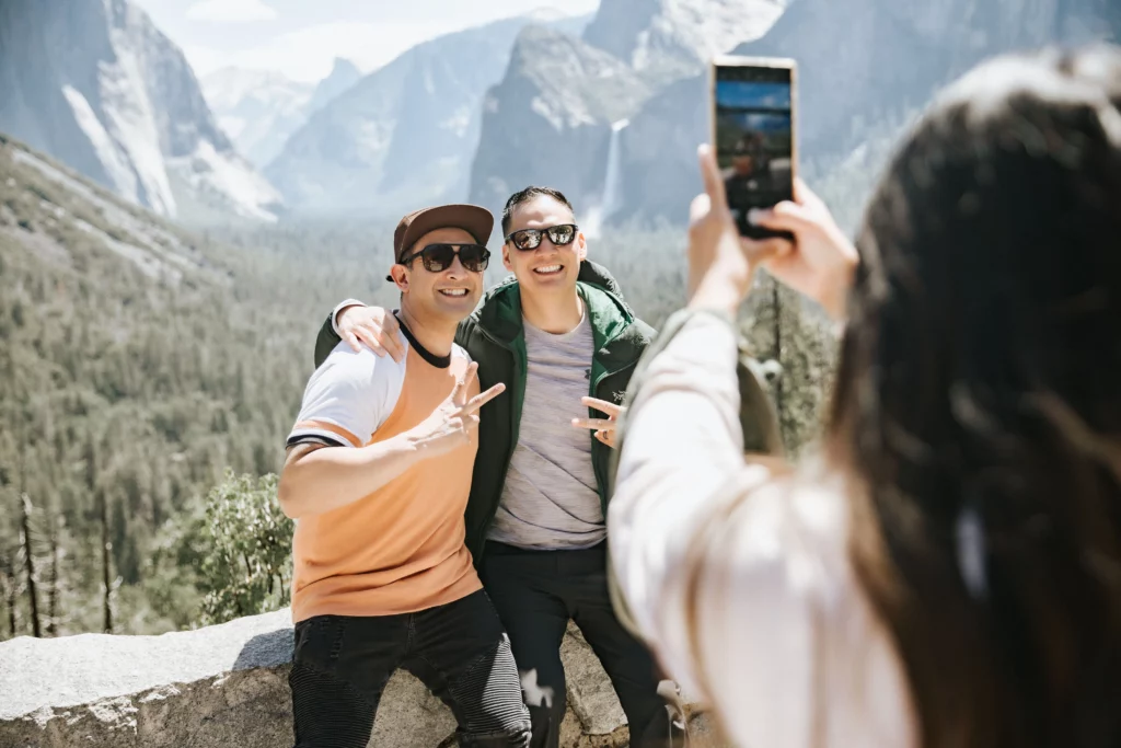 two guys are taking picture in front of tunnel view