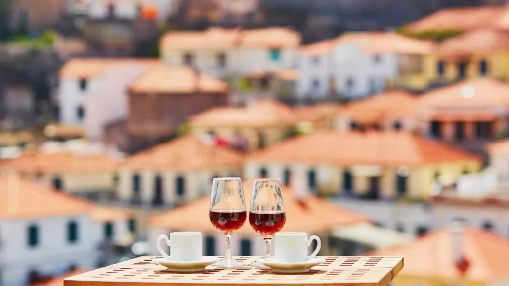 two glasses of red wine and two glasses of tea cups on the table