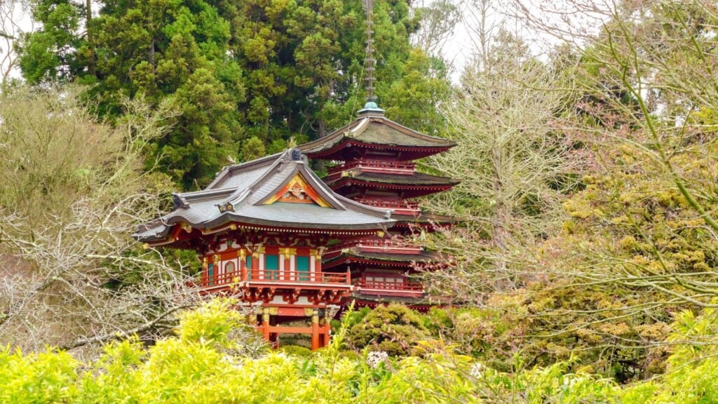 a red structured Japanese tea garden surrounded by trees