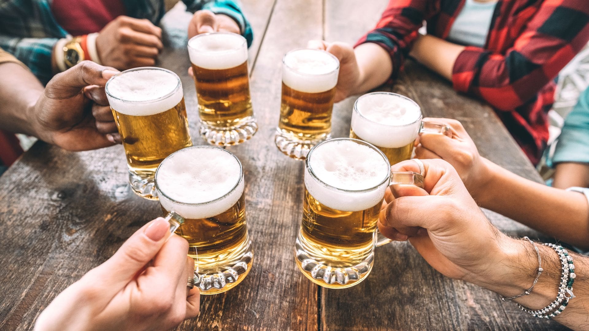 people toasting glass of beers 