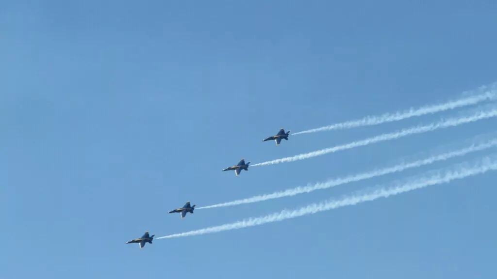 four aircrafts in the sky flying side by side 