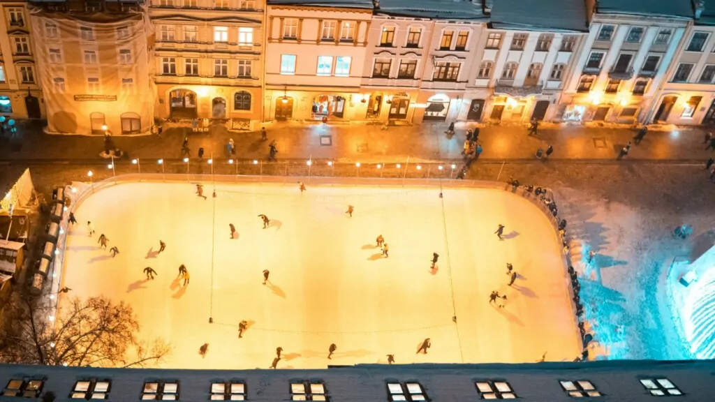 an aerial view of a skating rink at night 