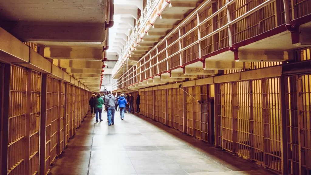 people walking between cells in Alcatraz prison