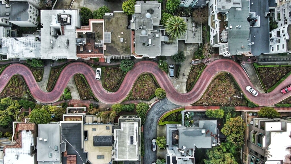 a zigzagged street in between houses